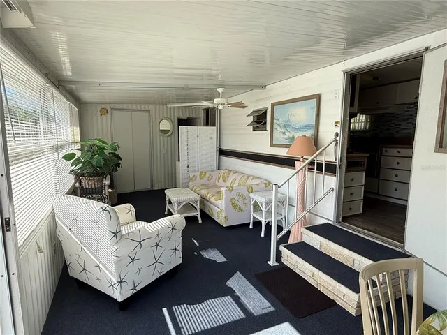a living room with furniture and flowers
