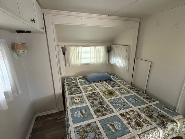 walk in closet with wooden floor