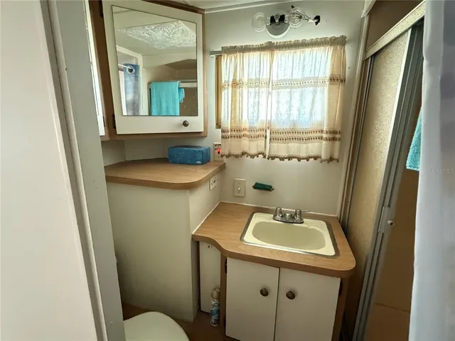 a bathroom with sink and mirror