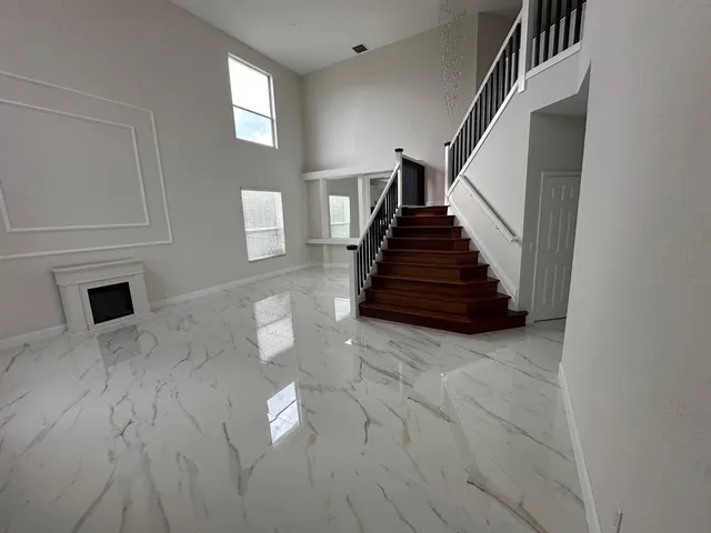 a view of entryway and hall with wooden floor