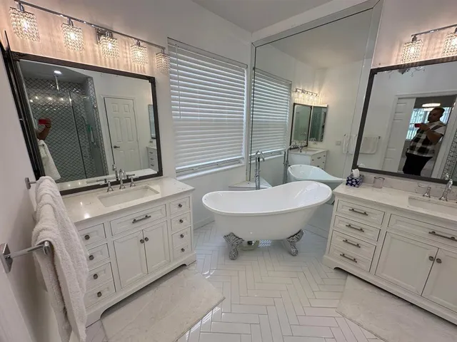 a bathroom with 2 sink double vanity and a mirror