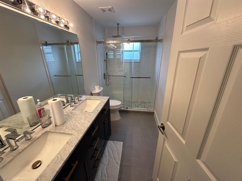 12763 Hyland Circle Boca Raton, FL 33428 - Photo 10 of 10 a bathroom with a sink and mirror