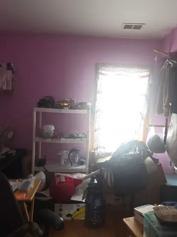 a bathroom with a walk in closet and wooden floor