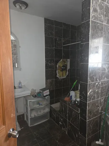 a bathroom with a granite countertop sink a toilet and mirror