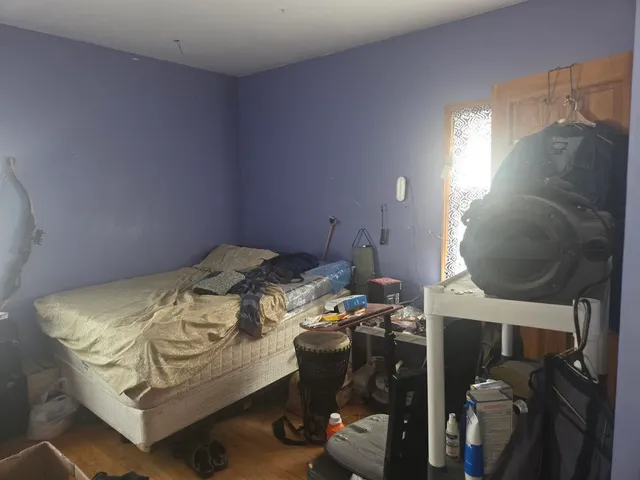 a bedroom with a bed and a mirror