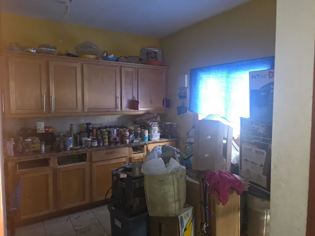 a kitchen with a refrigerator and cabinets