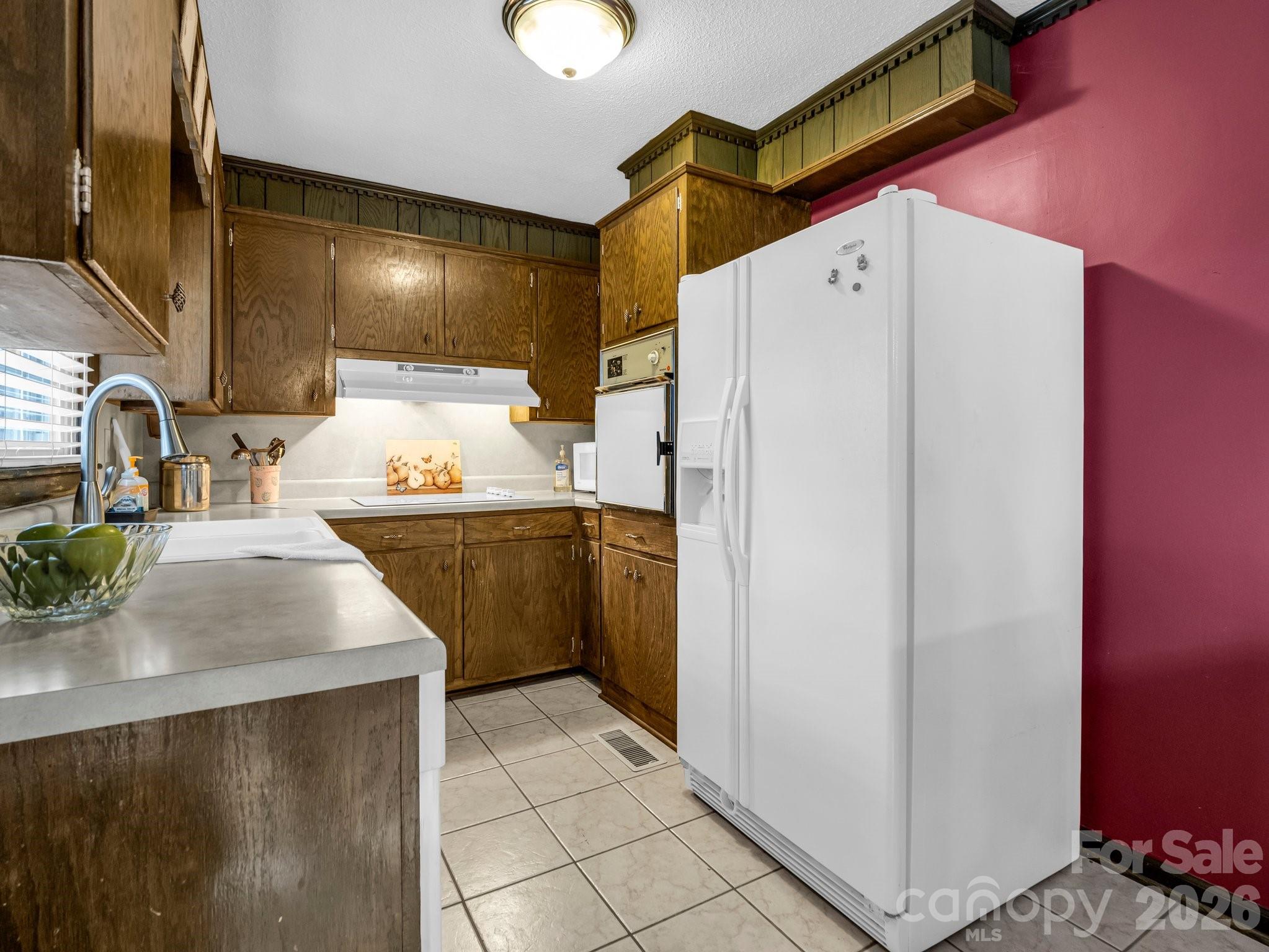 7392 Reeps Grove Church Road Vale, NC 28168 - Photo 13 of 30 a kitchen with a sink a refrigerator and cabinets