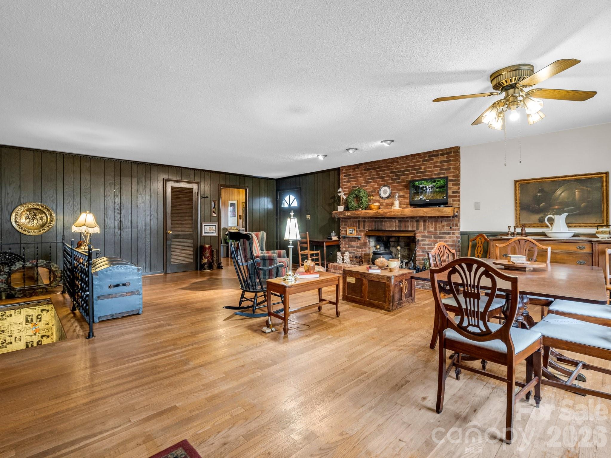 7392 Reeps Grove Church Road Vale, NC 28168 - Photo 6 of 30 a living room with furniture a fireplace and a flat screen tv