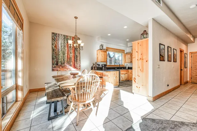 a living room with fireplace furniture and a large window