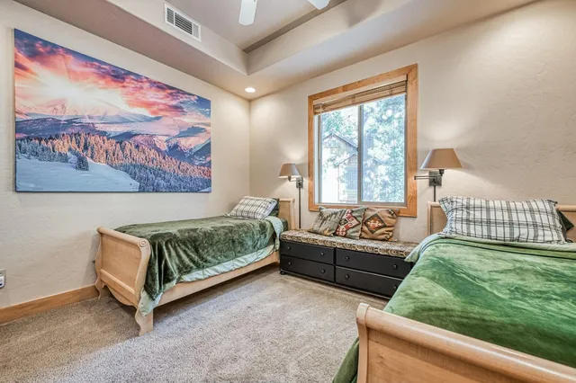 a en suite bathroom with a granite countertop sink and a mirror