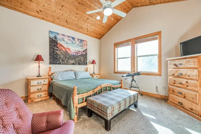 a living room with furniture a table and a large window