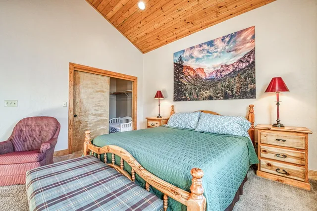 a living room with furniture a large window and a refrigerator