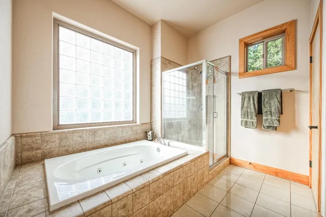 a bathroom with a granite countertop sink a toilet and shower