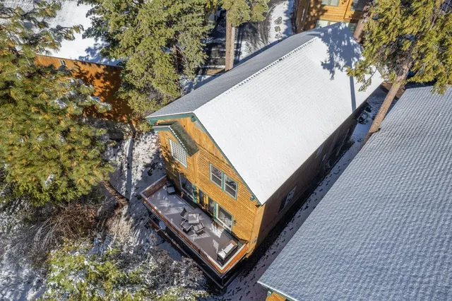 a living room with fireplace furniture and a large window