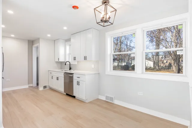 a kitchen with a stove a sink and a refrigerator