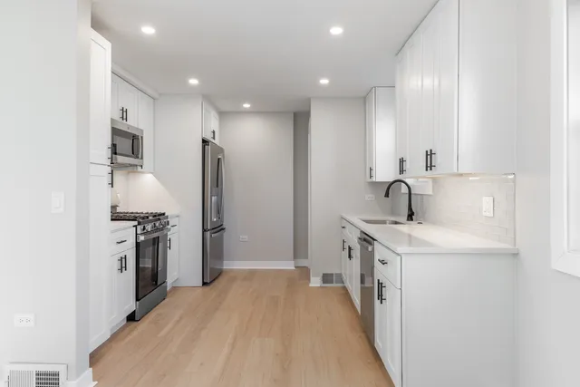a kitchen with a sink stove and refrigerator