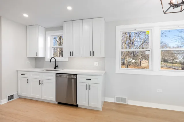 a view of cabinets a sink and a window in a room