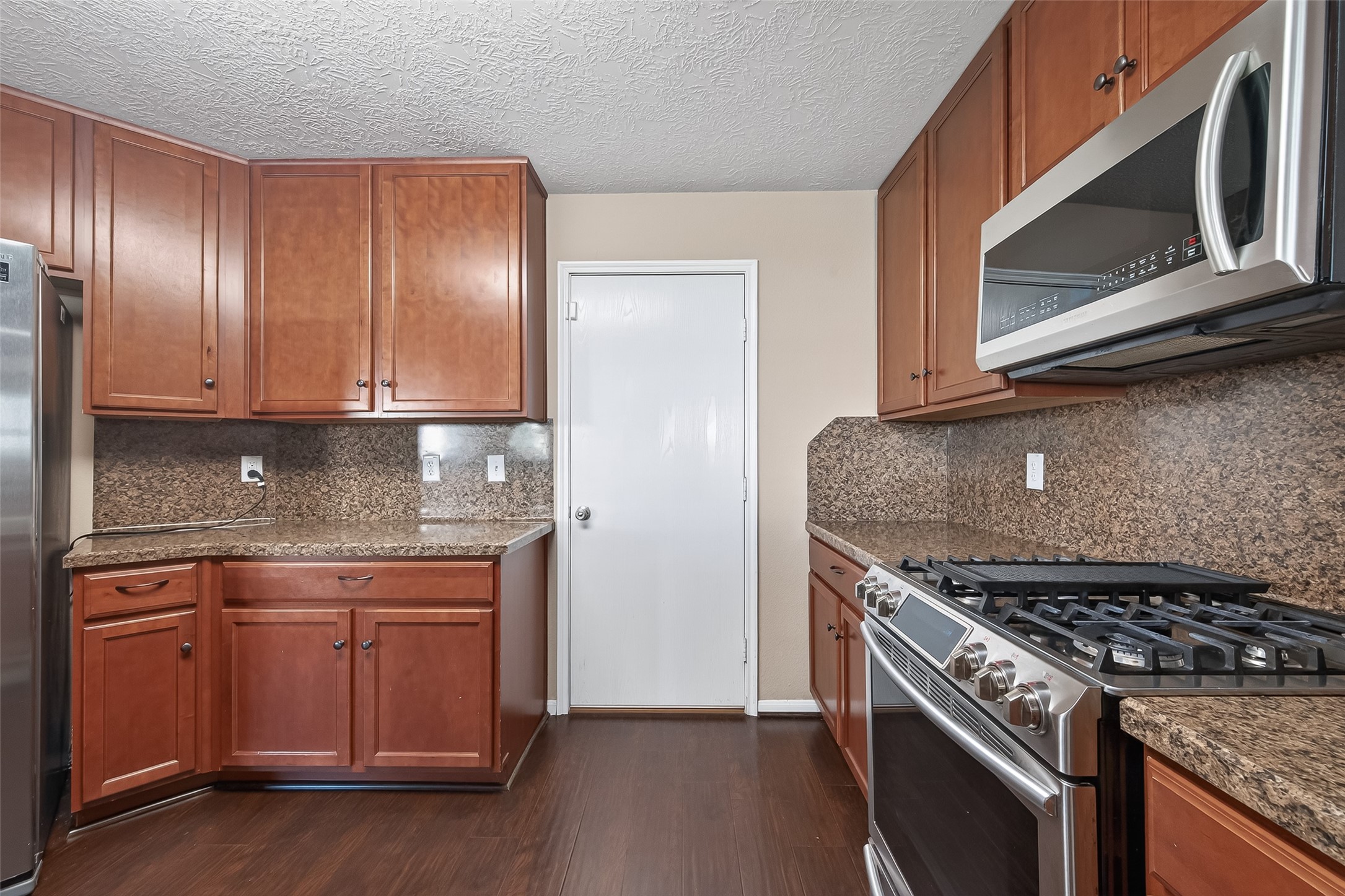 18110 Rexine Lane Cypress, TX 77433 - Photo 20 of 50 a kitchen with granite countertop stainless steel appliances a stove microwave and sink