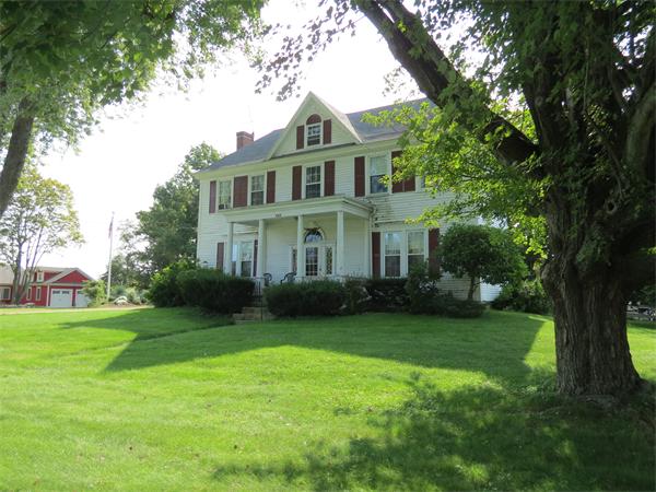 301 Boston Road Sutton, MA 01590 - Photo 1 of 30 a front view of a house with a garden