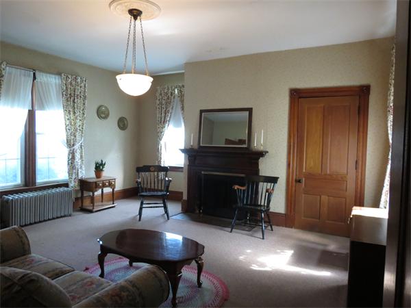 301 Boston Road Sutton, MA 01590 - Photo 8 of 30 a living room with furniture a fireplace and a chandelier