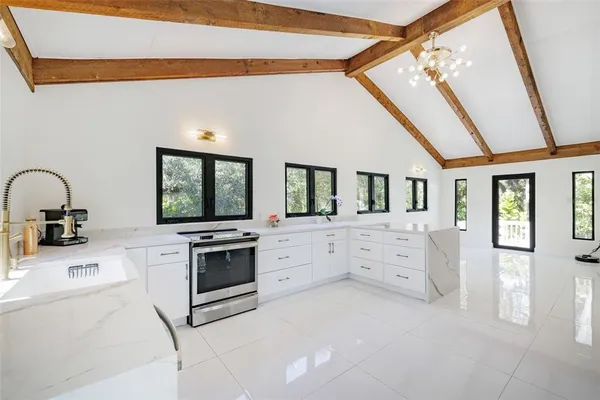 a living room with furniture and a floor to ceiling window