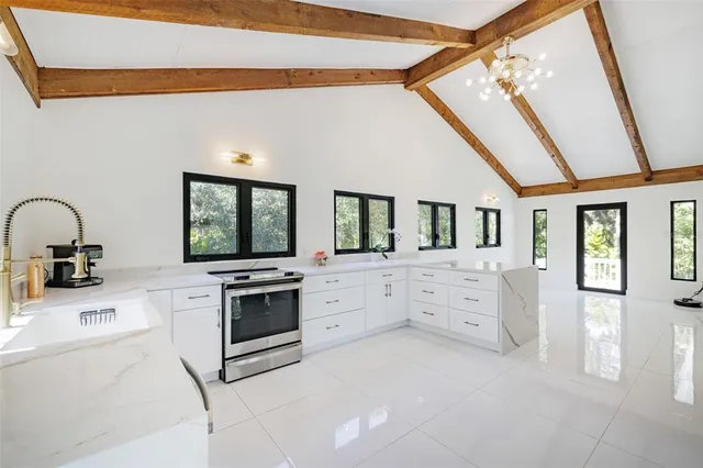 a living room with furniture and a floor to ceiling window