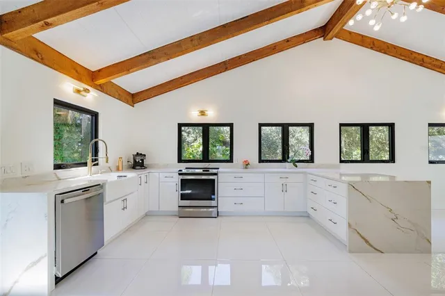 a bathroom with a granite countertop sink a toilet a mirror and shower