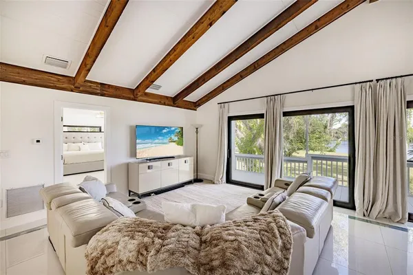a bedroom with a bed and a large window