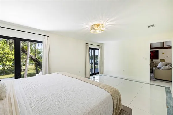 a bedroom with a bed next to a window with outer view