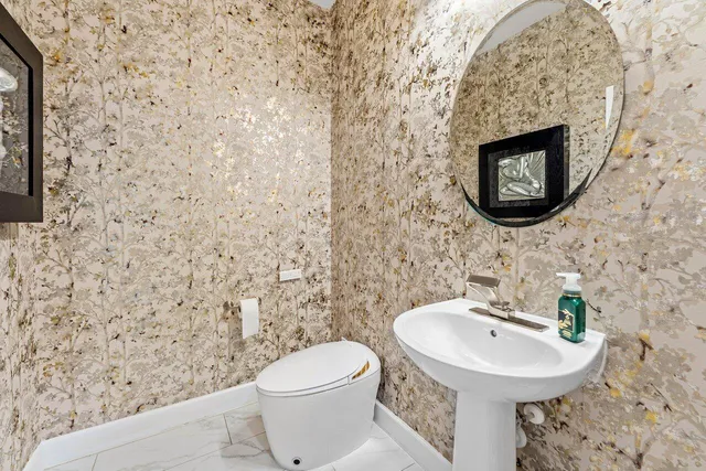 a bathroom with a double vanity sink large mirror and a bathtub