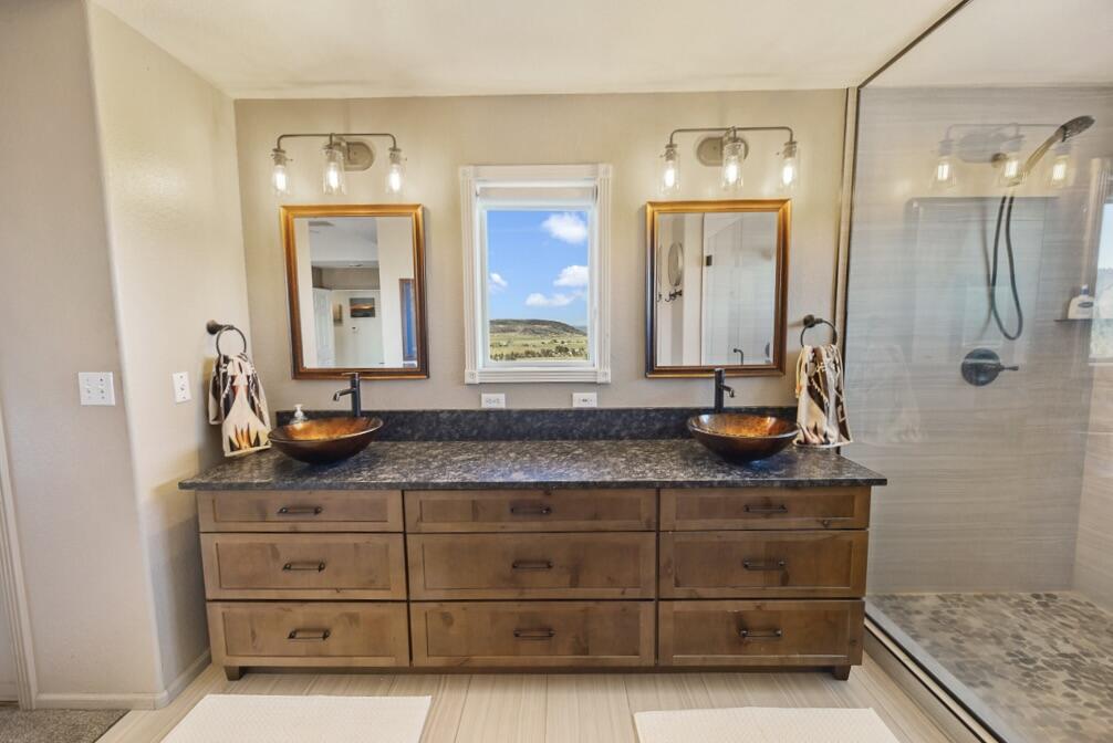 13351 Crystal Springs Road Klamath Falls, OR 97603 - Photo 33 of 51 a bathroom with a granite countertop sink a mirror and shower