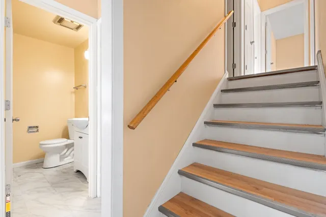 a bathroom with a toilet and a mirror