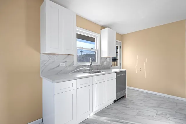 a kitchen with a sink and cabinets