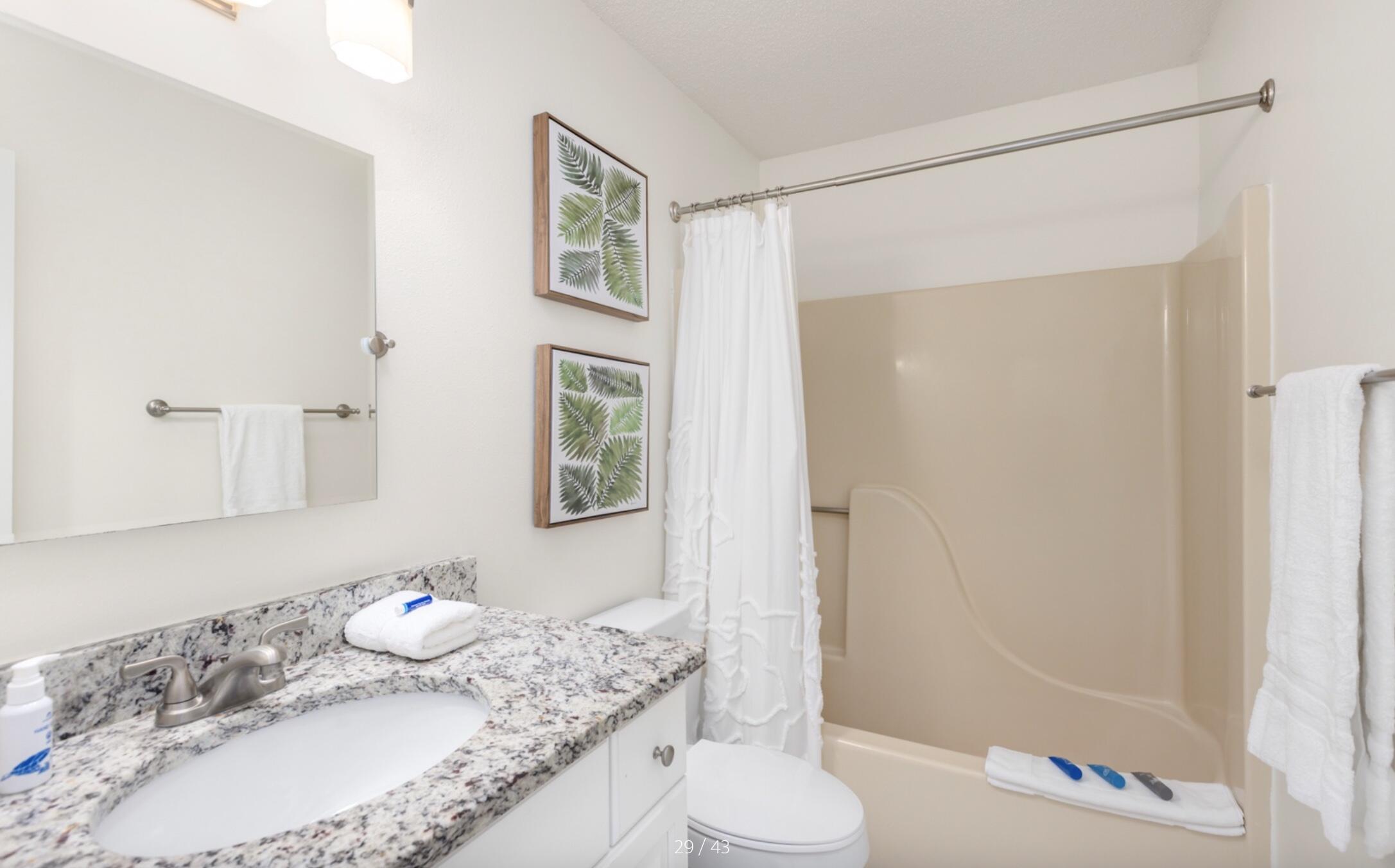 3799 East County Highway 30A, Unit E12 Santa Rosa Beach, FL 32459 - Photo 17 of 34 a bathroom with a granite countertop sink and a mirror