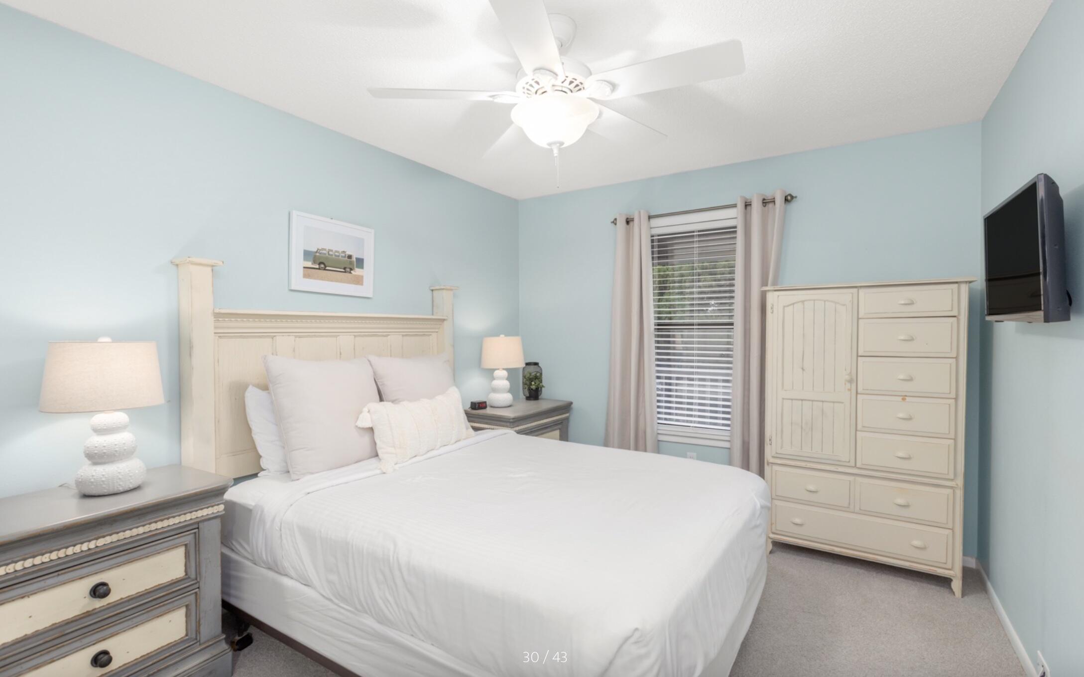 3799 East County Highway 30A, Unit E12 Santa Rosa Beach, FL 32459 - Photo 18 of 34 a bedroom with a bed a dresser and a flat screen tv