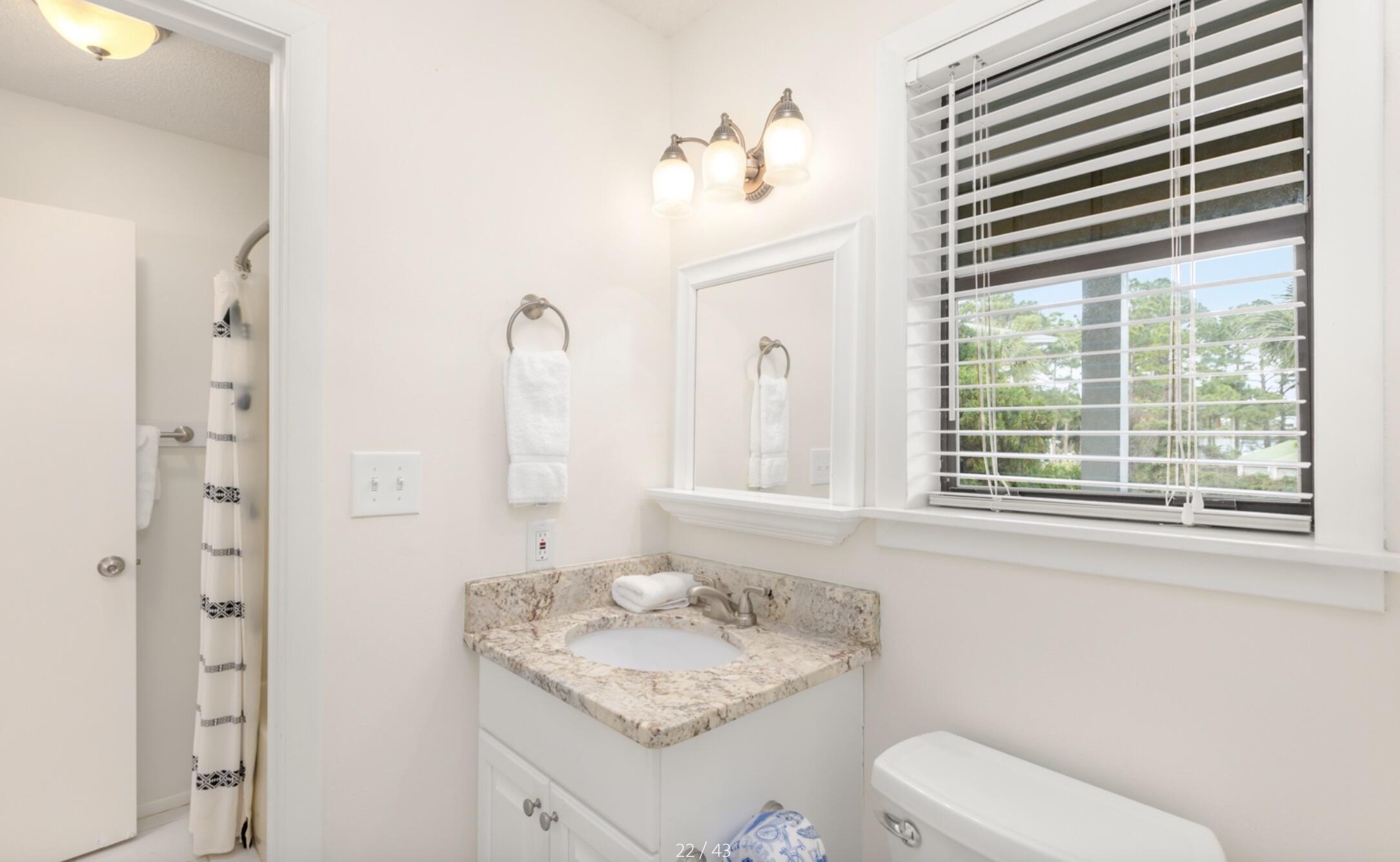 3799 East County Highway 30A, Unit E12 Santa Rosa Beach, FL 32459 - Photo 20 of 34 a bathroom with a toilet sink and mirror