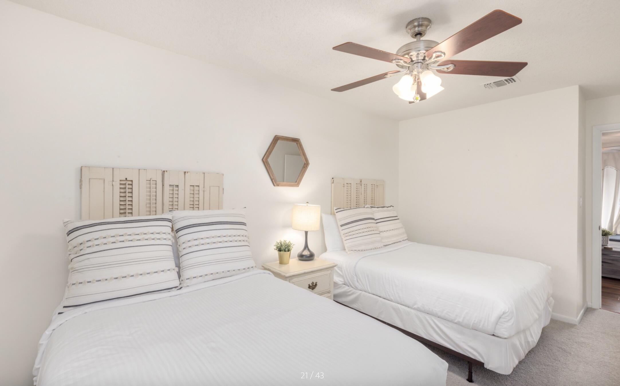 3799 East County Highway 30A, Unit E12 Santa Rosa Beach, FL 32459 - Photo 23 of 34 a bedroom with bed and a chandelier