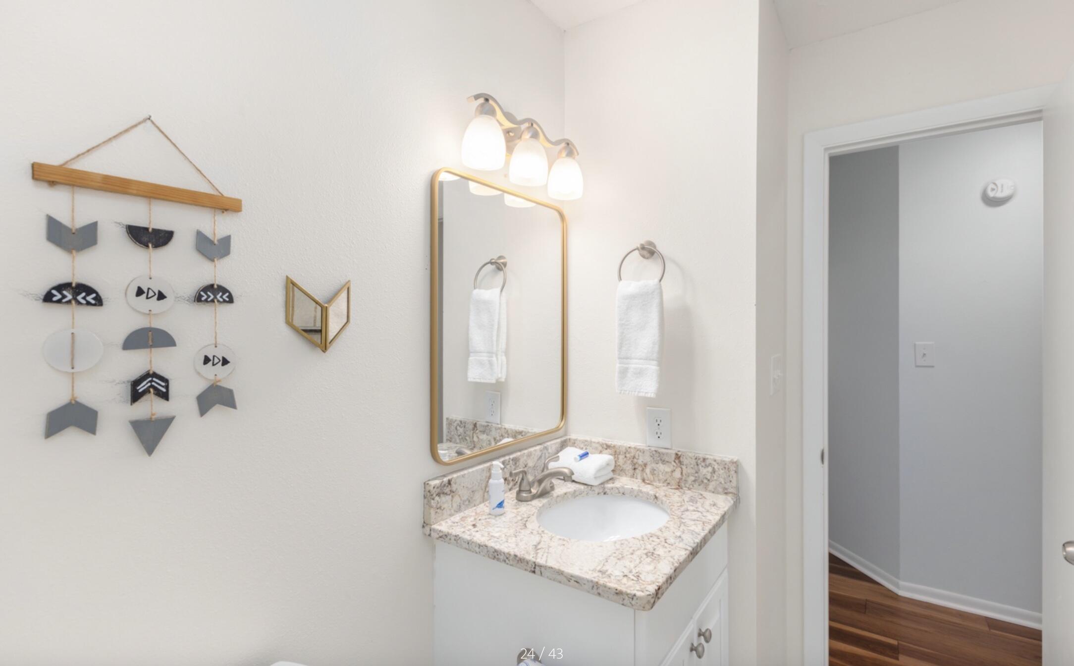 3799 East County Highway 30A, Unit E12 Santa Rosa Beach, FL 32459 - Photo 24 of 34 a bathroom with a granite countertop sink and a mirror