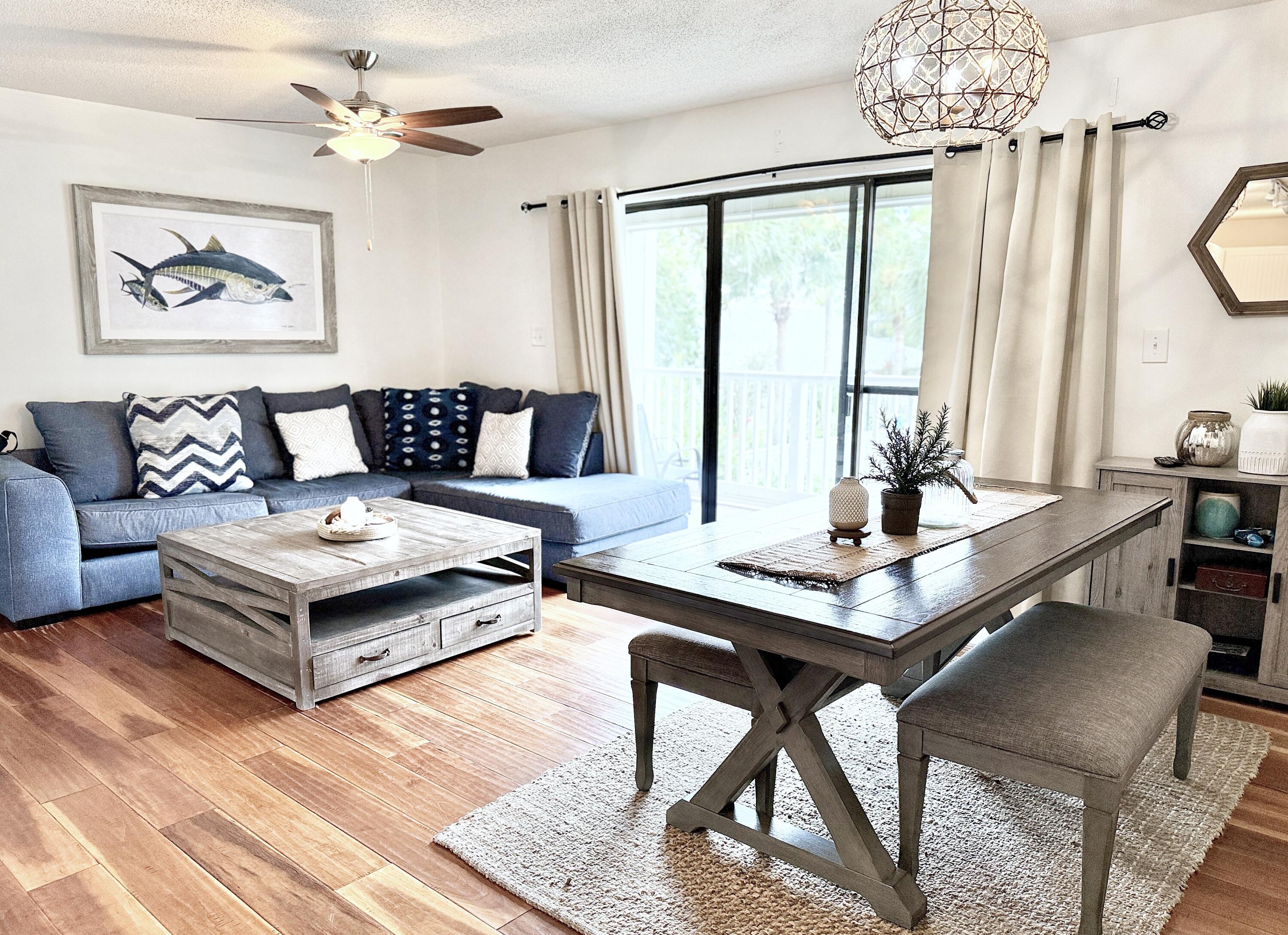 3799 East County Highway 30A, Unit E12 Santa Rosa Beach, FL 32459 - Photo 4 of 34 a living room with furniture and a chandelier