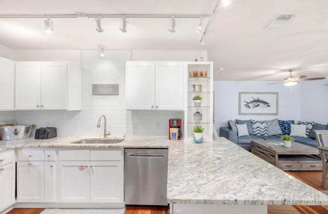 a kitchen with sink a stove and cabinets