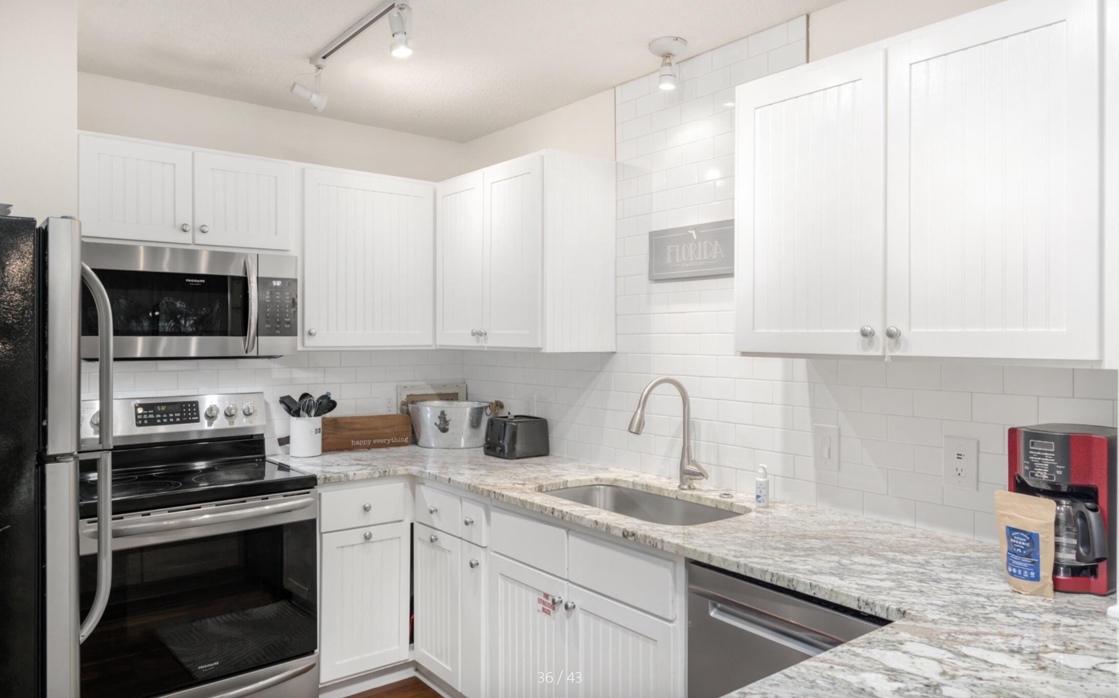 3799 East County Highway 30A, Unit E12 Santa Rosa Beach, FL 32459 - Photo 10 of 34 a kitchen with stainless steel appliances granite countertop a sink and a stove