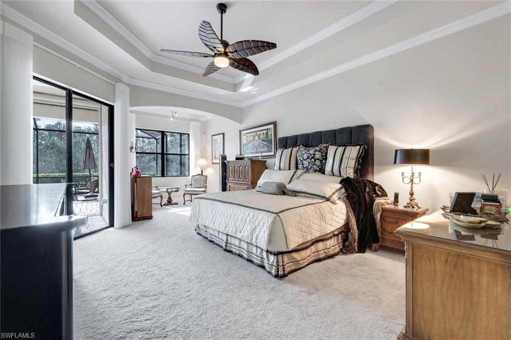 11050 Longwing Drive Fort Myers, FL 33912 - Photo 12 of 43 Carpeted bedroom with ornamental molding, a tray ceiling, access to exterior, and ceiling fan