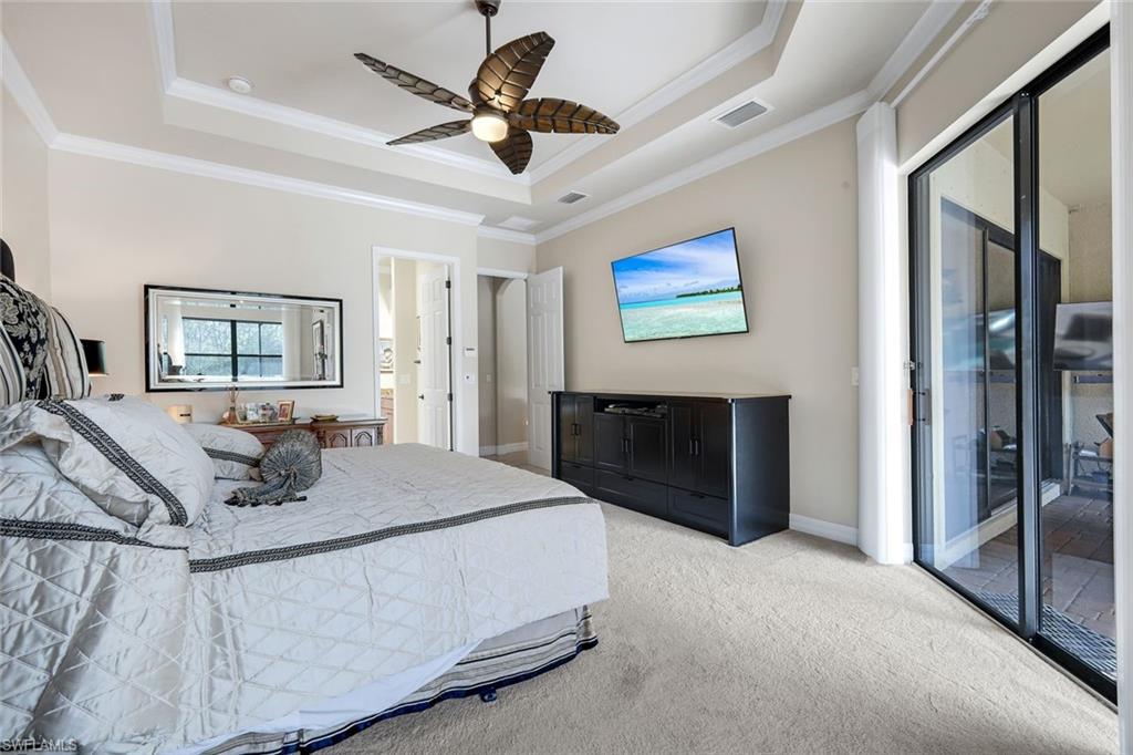 11050 Longwing Drive Fort Myers, FL 33912 - Photo 13 of 43 Carpeted bedroom with access to exterior, a raised ceiling, a ceiling fan, and crown molding