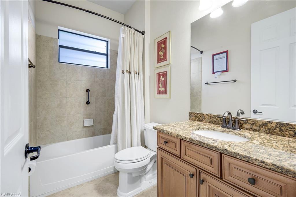 11050 Longwing Drive Fort Myers, FL 33912 - Photo 19 of 43 Bathroom featuring vanity, shower / bath combo, and light tile patterned flooring