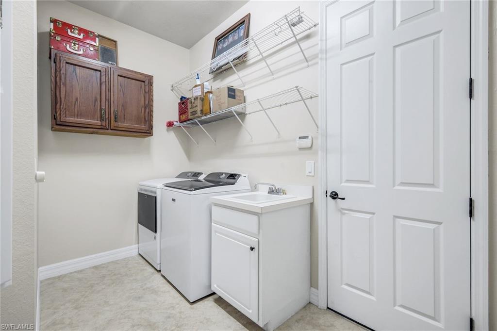 11050 Longwing Drive Fort Myers, FL 33912 - Photo 23 of 43 Laundry area featuring cabinet space and washer and clothes dryer