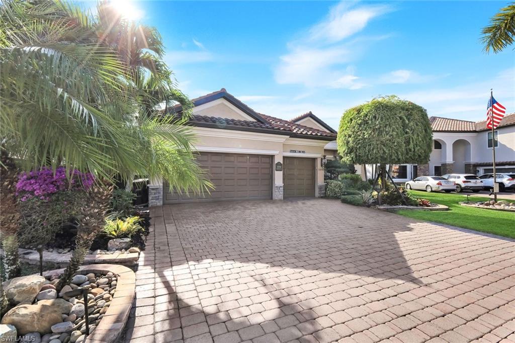 11050 Longwing Drive Fort Myers, FL 33912 - Photo 30 of 43 View of front facade featuring decorative driveway, stucco siding, an attached garage, and a tile roof