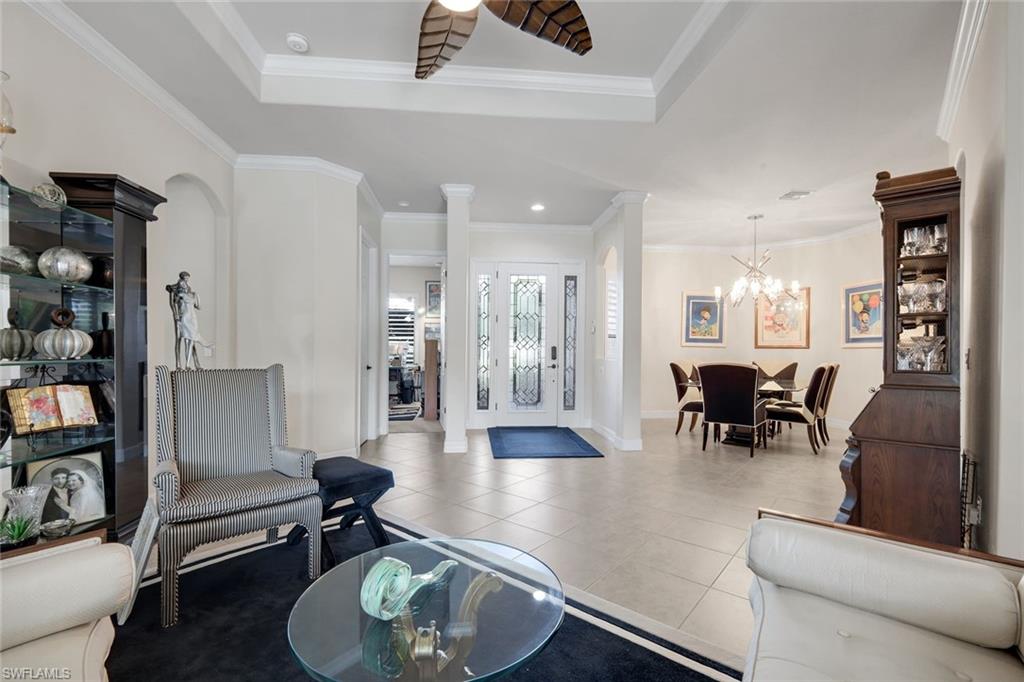 11050 Longwing Drive Fort Myers, FL 33912 - Photo 3 of 43 Foyer featuring light tile patterned flooring, ornamental molding, ornate columns, a chandelier, and recessed lighting