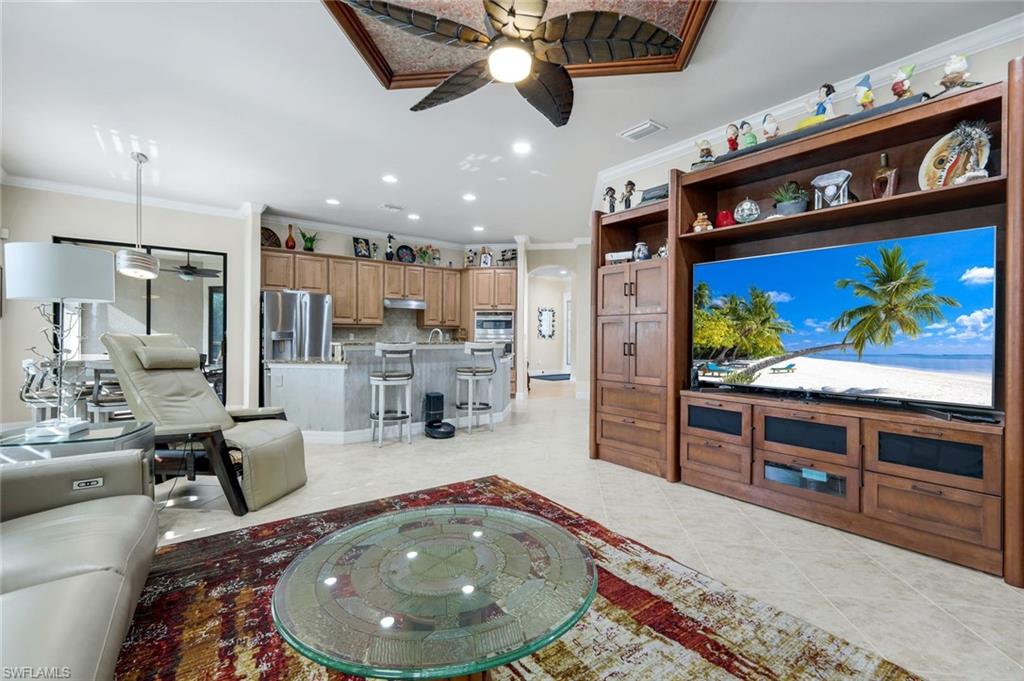 11050 Longwing Drive Fort Myers, FL 33912 - Photo 4 of 43 Living area with a ceiling fan, ornamental molding, recessed lighting, arched walkways, and light tile patterned flooring