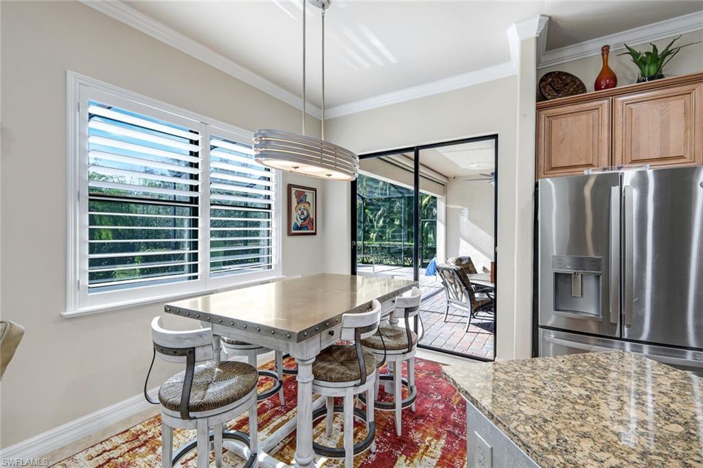 11050 Longwing Drive Fort Myers, FL 33912 - Photo 9 of 43 Dining area featuring ornamental molding and baseboards