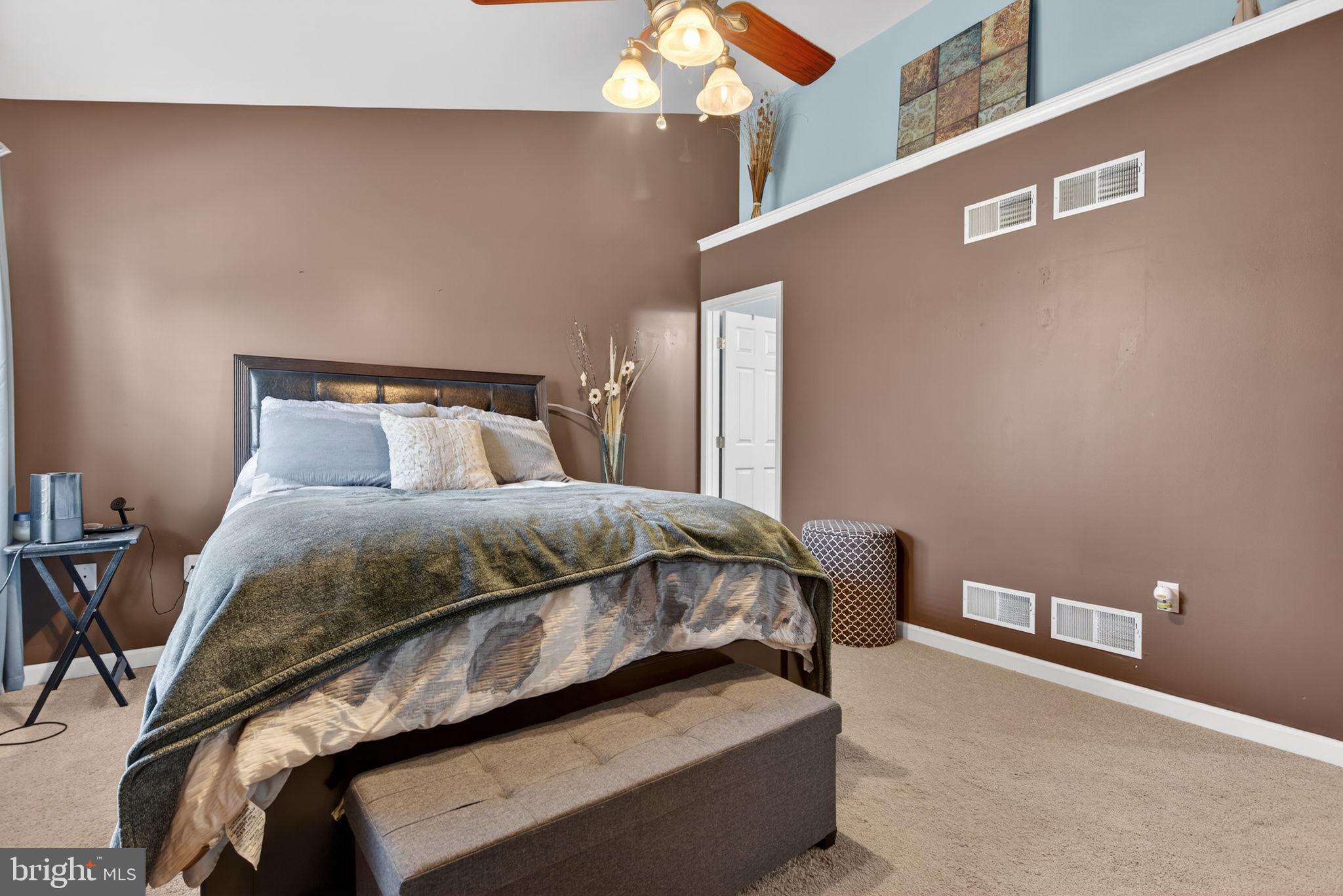 2436 Schultz Way, Unit 19 York, PA 17402 - Photo 17 of 30 a bedroom with a bed and a chandelier